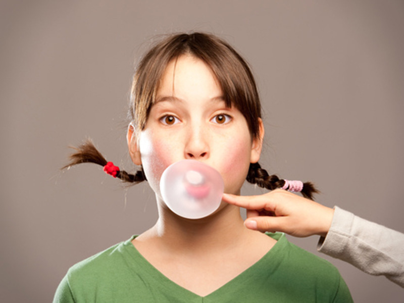 girl blowing chewing gum