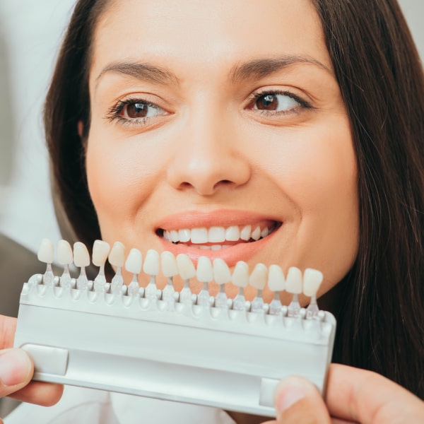 Woman choosing the right shade for composite veneers in Florence, KY